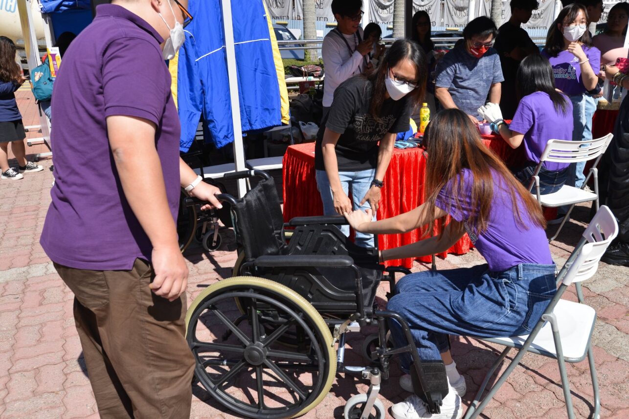 Participants at D&I Carnival 2024 are engaging in the wheelchair experience workshop.