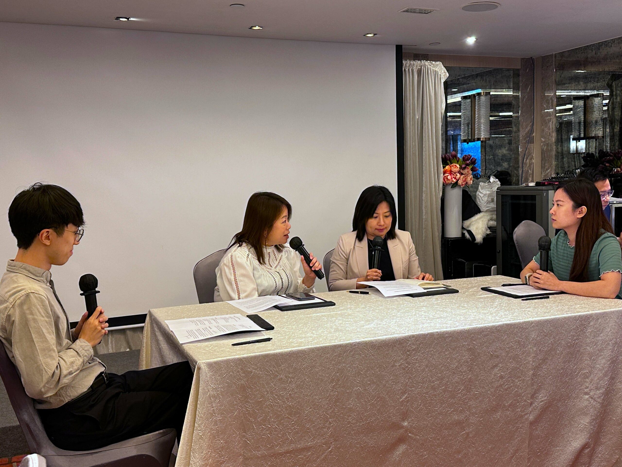 Four participants (Group A) sit around a table, each holding a microphone, engaged in a conciliation role play session.