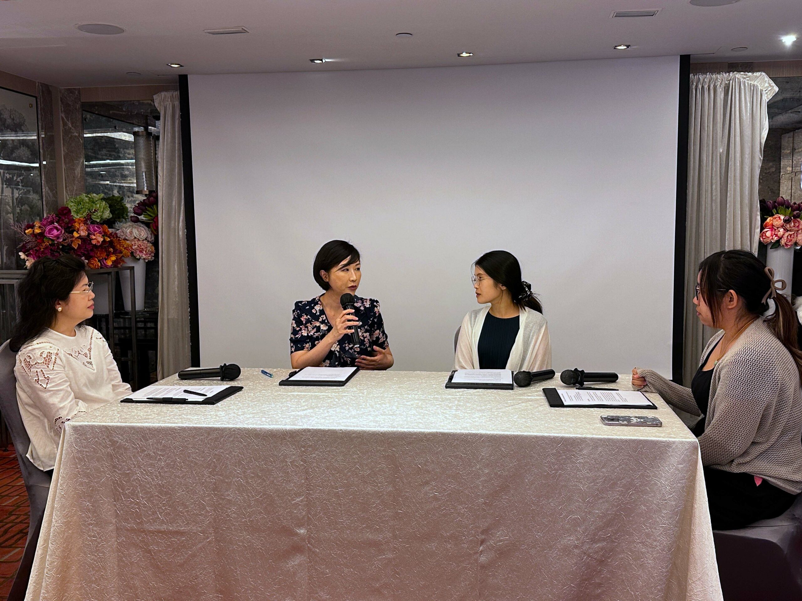 Four participants (Group B) sit around a table, each holding a microphone, engaged in a conciliation role play session.